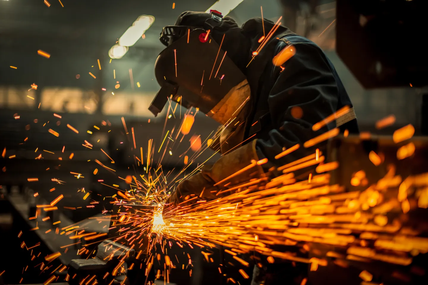 A welder wearing wearing a welding helmet
